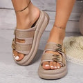 Women's apricot suede slippers with thick rubber sole on wooden floor