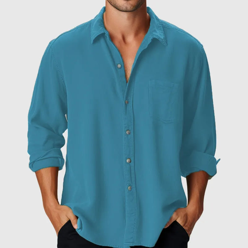 Man wearing a loose-fitting long sleeve beach shirt with a stand collar, available in various colours.