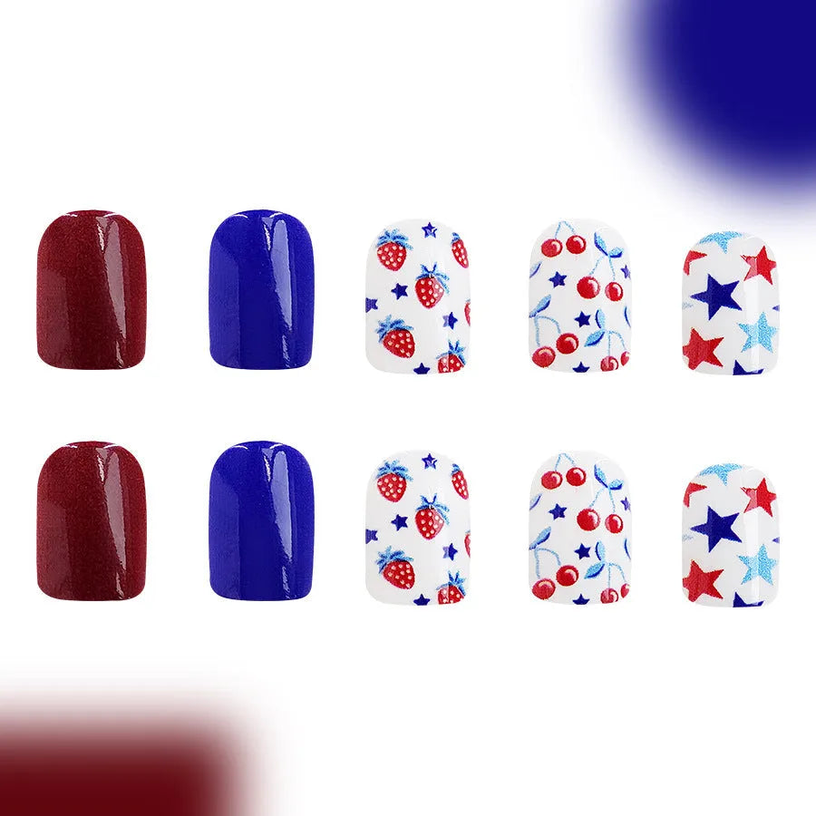 Short glossy false nails with red and blue strawberry and cherry Independence Day design