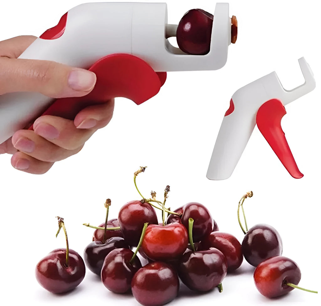 Manual handheld cherry kernel remover kitchen gadget with stainless steel blades and clear pit catcher.