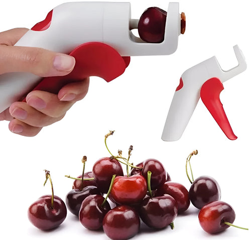 Manual handheld cherry kernel remover kitchen gadget with stainless steel blades and clear pit catcher.