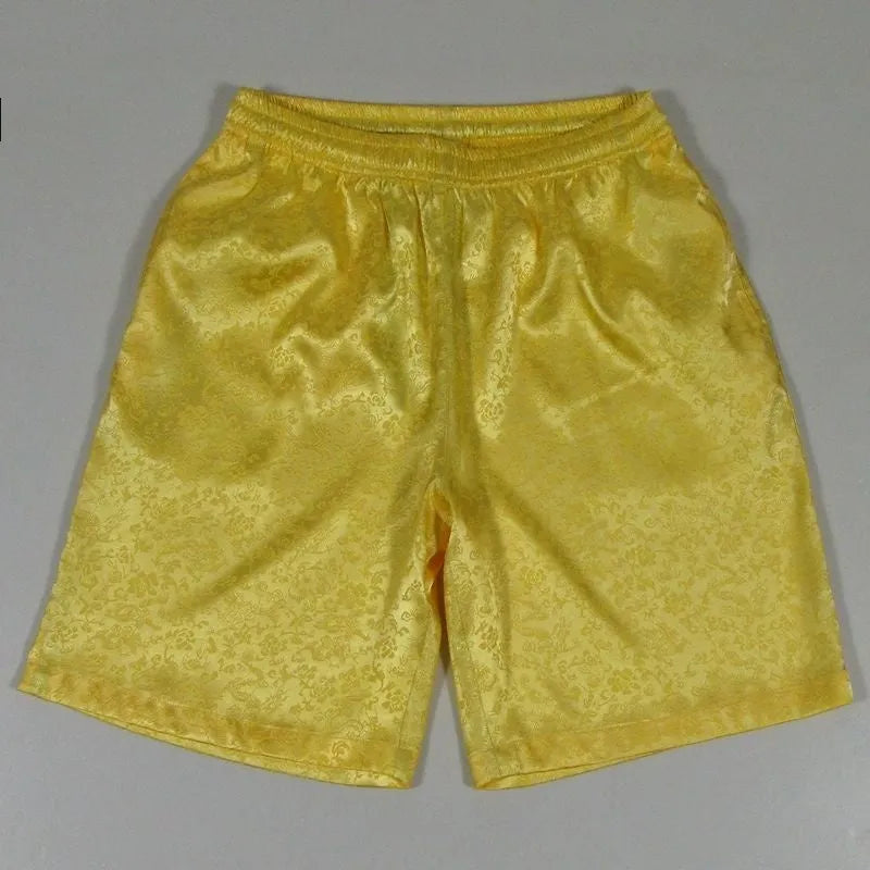 Men's traditional black Tang suit shorts with elasticated drawstring waistband laid flat