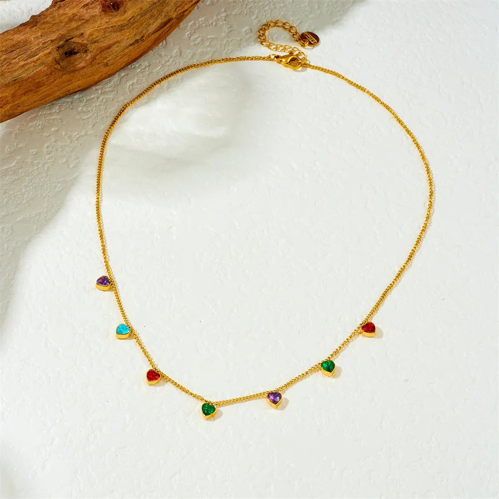 Gold-plated stainless steel heart necklace on a model, showing adjustable length.