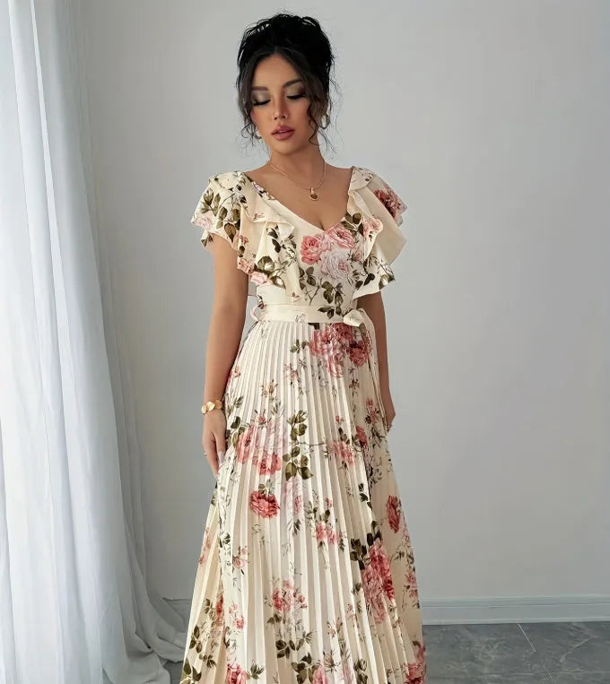 Apricot floral print v-neck dress with ruffled sleeves and a long, pleated swing skirt.