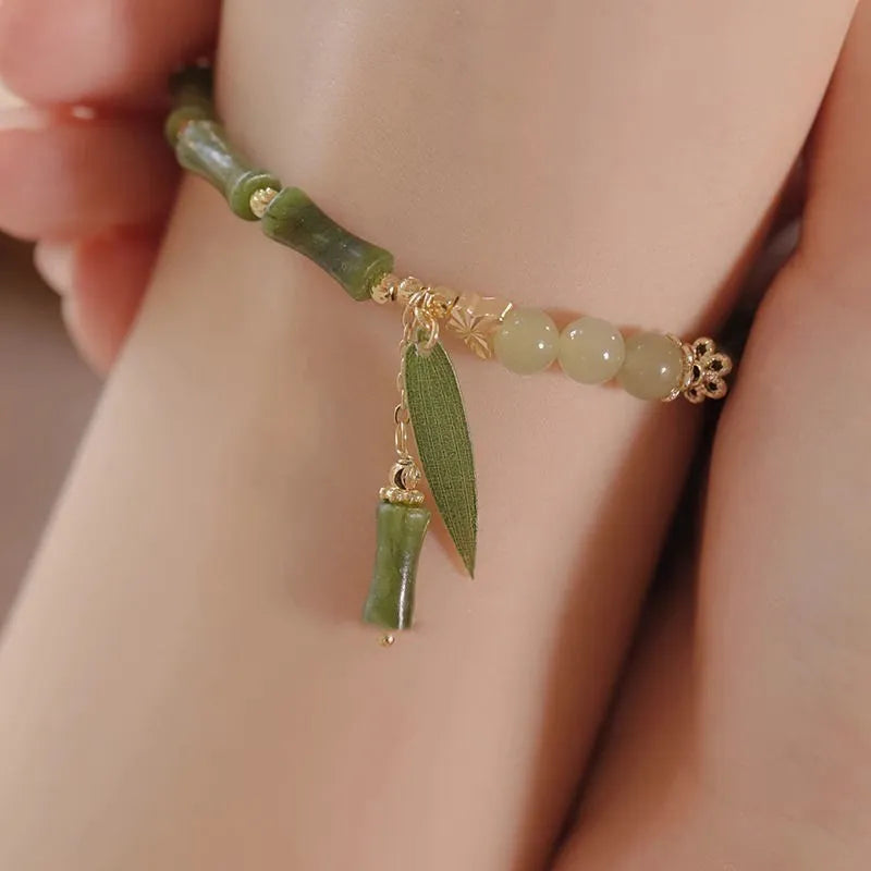 Handmade Chinese style glass bracelet with bamboo joint beads in a red Lvzhu Duobao design.