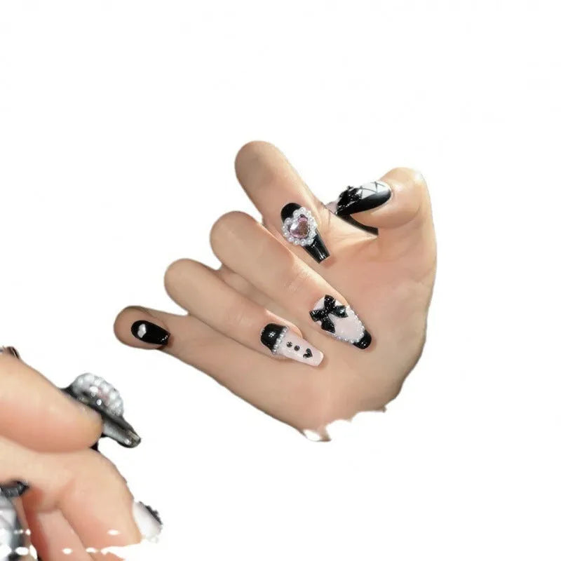 Black and pink hand-painted heart design detachable manicure showing bow pattern and size options