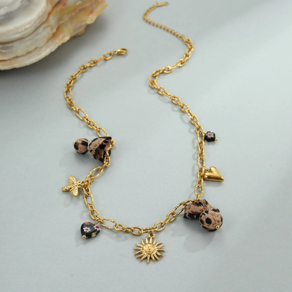 Gold-plated leopard pendant necklace with love heart and flower detailing on adjustable chain