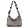 Washed canvas crossbody bag for women in black with single shoulder strap and clamshell shape