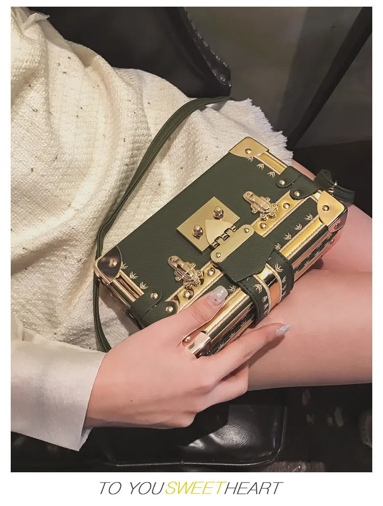 Women's structured shoulder bag with flap closure and adjustable crossbody strap in black or green
