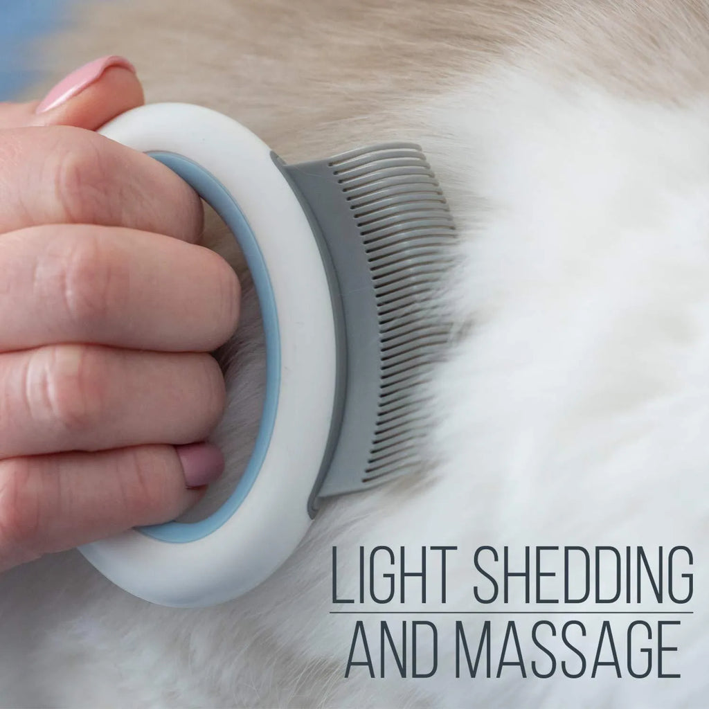 Blue pet deshedding comb with soft teeth and ergonomic plastic handle on a white background.