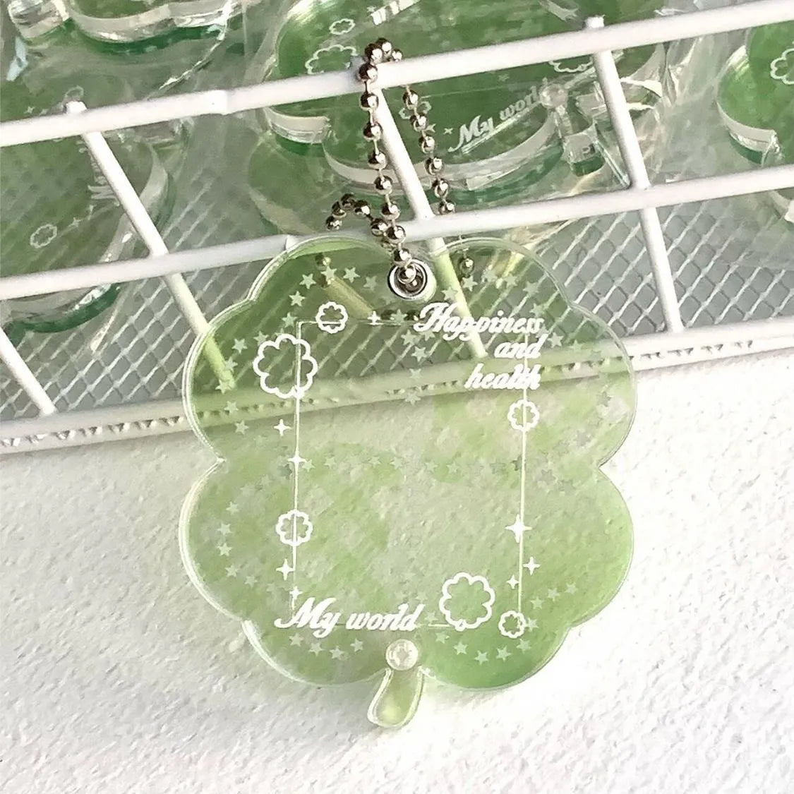 Acrylic four-leaf clover shape keychain pendant for phones in blue, green, or mint.