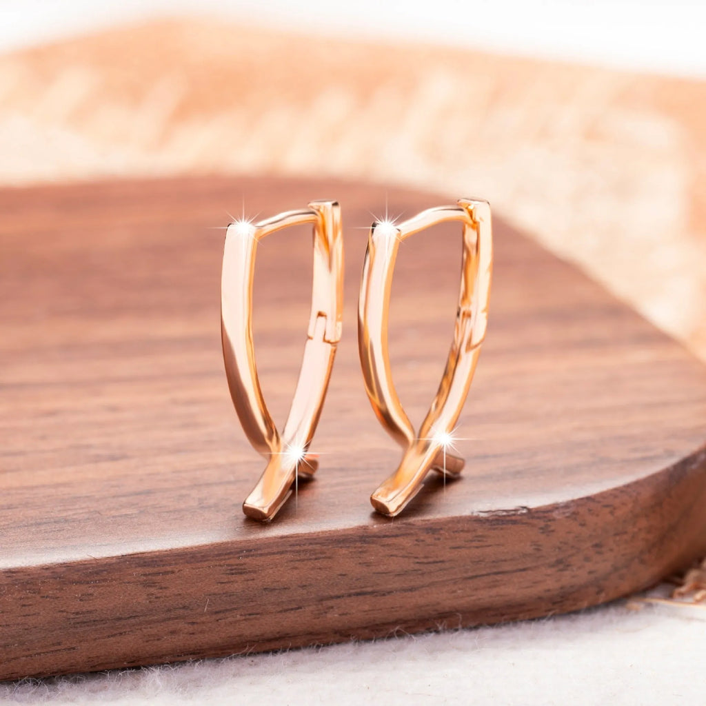 Rose gold cross shaped earrings with polished finish on copper material