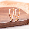 Rose gold cross shaped earrings with polished finish on copper material