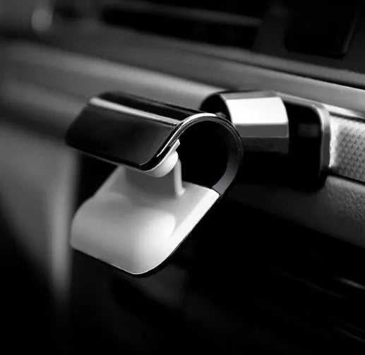 Black universal car phone holder with 360-degree rotation head mounted on a car air vent