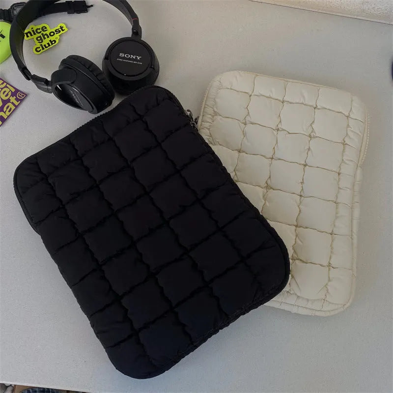 Black and white nylon laptop bag for 11-inch to 15.6-inch devices with large storage capacity.