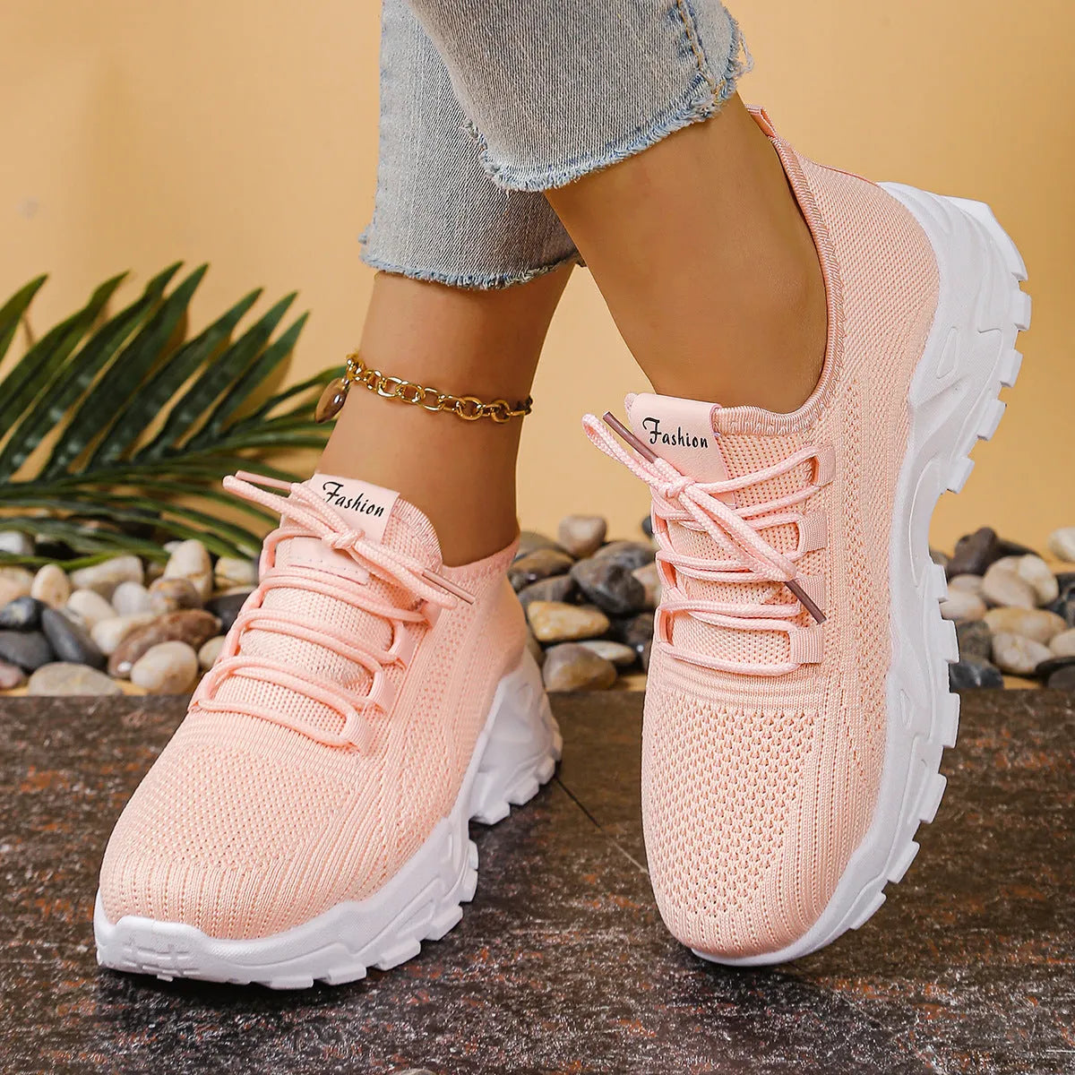 Women's low-top white mesh sports shoes with platform sole and front laces on a grey background.