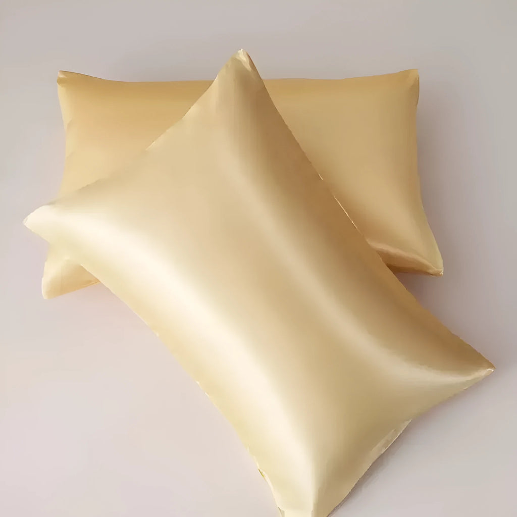A pair of solid colour satin pillowcases in a chosen shade, showing the smooth plain weave fabric texture.