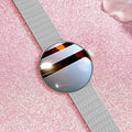 Women's smart watch with circular colour screen and metal strap on a wrist.