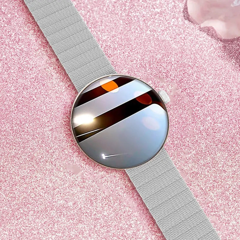 Women's smart watch with circular colour screen and metal strap on a wrist.