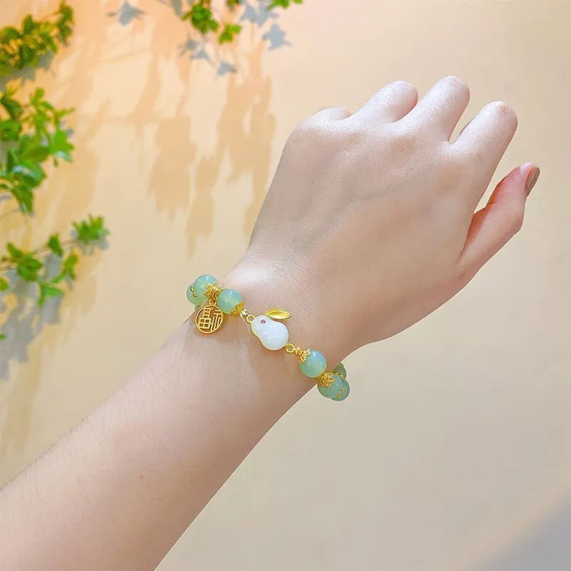 Handmade Chinese style glass bracelet with bamboo joint beads in a red Lvzhu Duobao design.