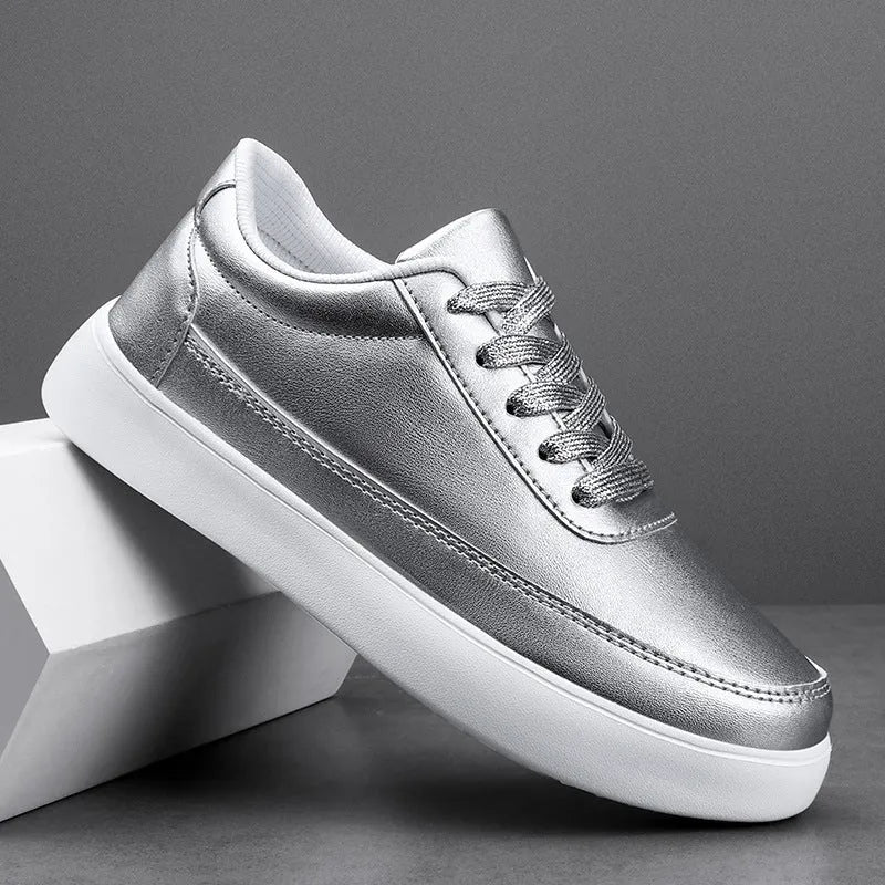 Women's white leather flat casual shoes with lace-up front on a plain background.