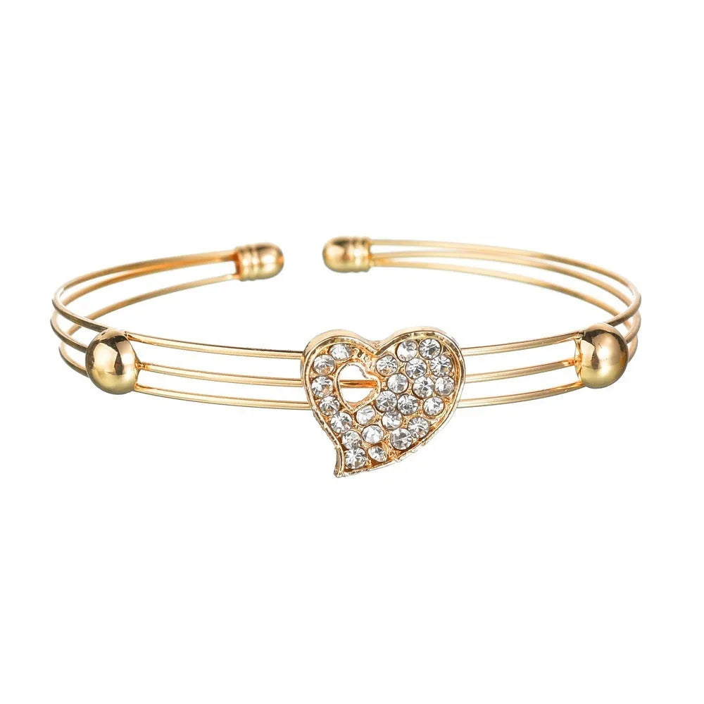 Gold-tone women's jewellery set with adjustable necklace, earrings, and hand decoration featuring love heart pendant