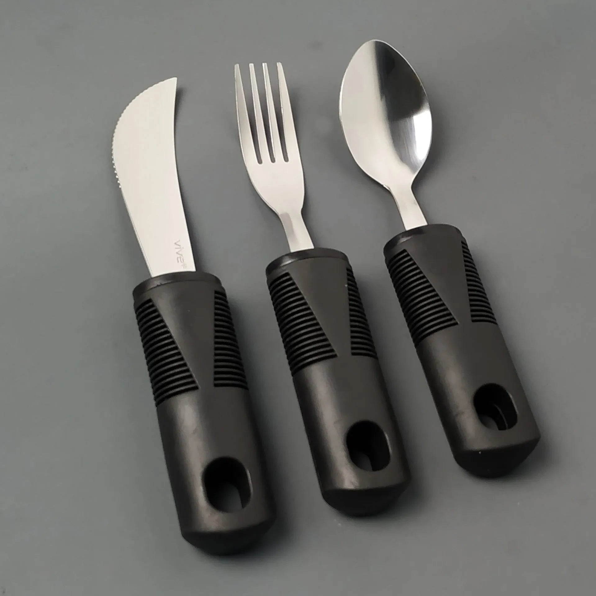 Stainless steel adaptive eating utensils with rubber anti-shake handles for elderly dining assistance