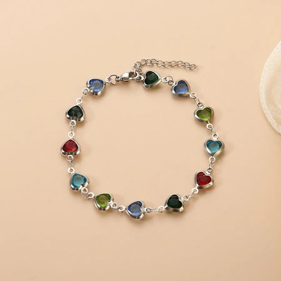 Devil's Eye geometric heart bracelet in stainless steel, shown in colourful, blue, green, and red finishes.