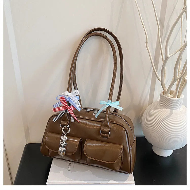 Retro brown pillow-shaped women's shoulder handbag with a flap closure and double strap