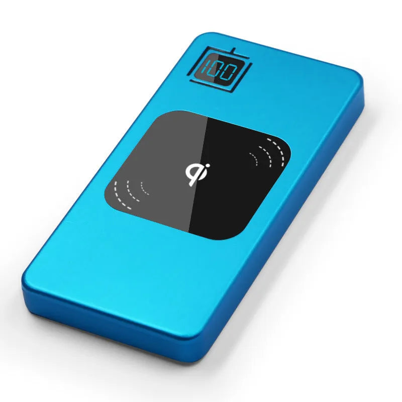Black portable power bank with LCD display showing battery percentage, next to a smartphone for scale.
