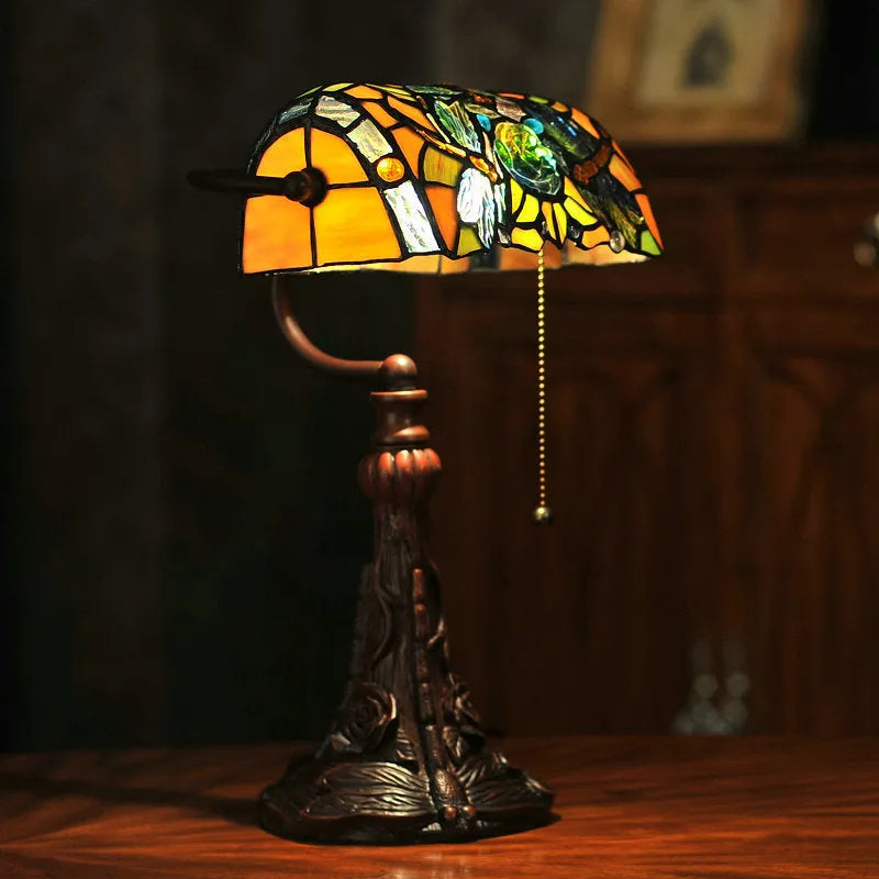 10-inch Tiffany style stained glass table lamp with resin base on a wooden desk.