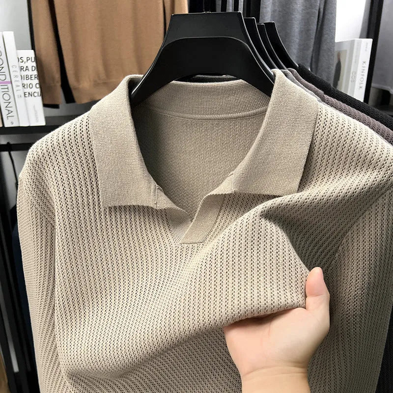 Men's loose green pullover sweater on a hanger, casual autumn wear.