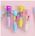 A cartoon-themed press-type ballpoint pen showing four-colour cartridge and a random print design on a silicone and plastic barrel.