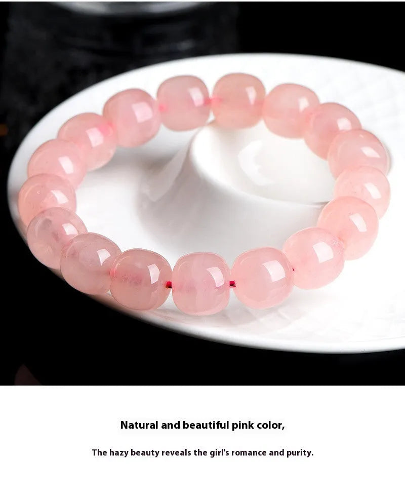 Pink crystal barrel bead stretch bracelet with 8-10mm polished beads on a wrist.