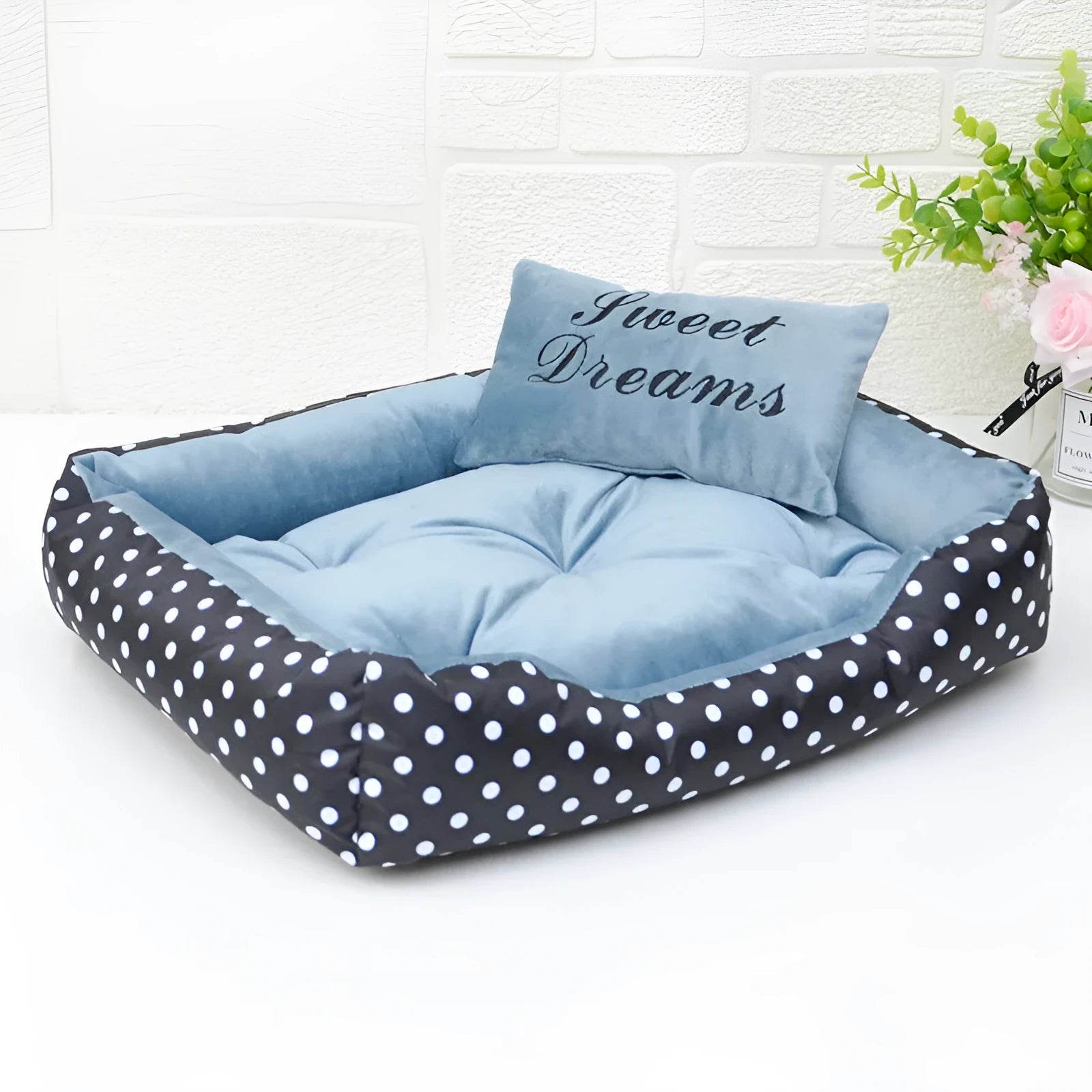 Polka dot printed square dog bed with a matching embroidery pillow in rose red, shown in a small size.