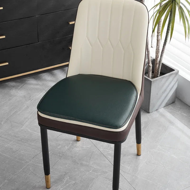 Brown leather horseshoe-shaped seat cushion with non-slip backing on a wooden chair.