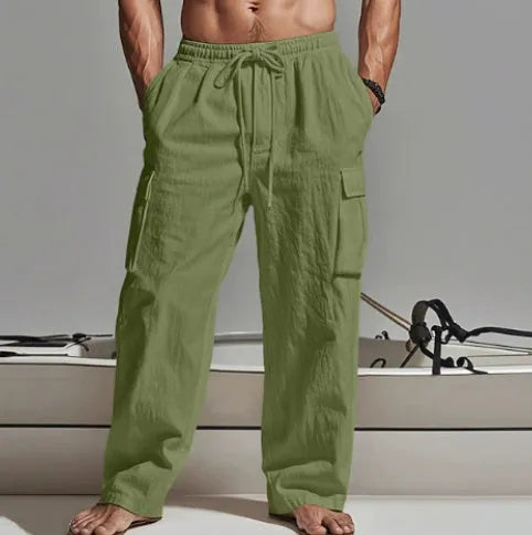 Man wearing light army green loose cotton wide-leg casual trousers with a mid waist.