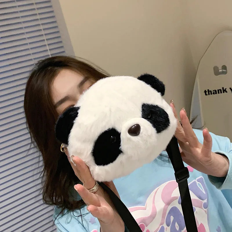 Cylindrical plush crossbody bag with panda head design showing outer sandwich pocket