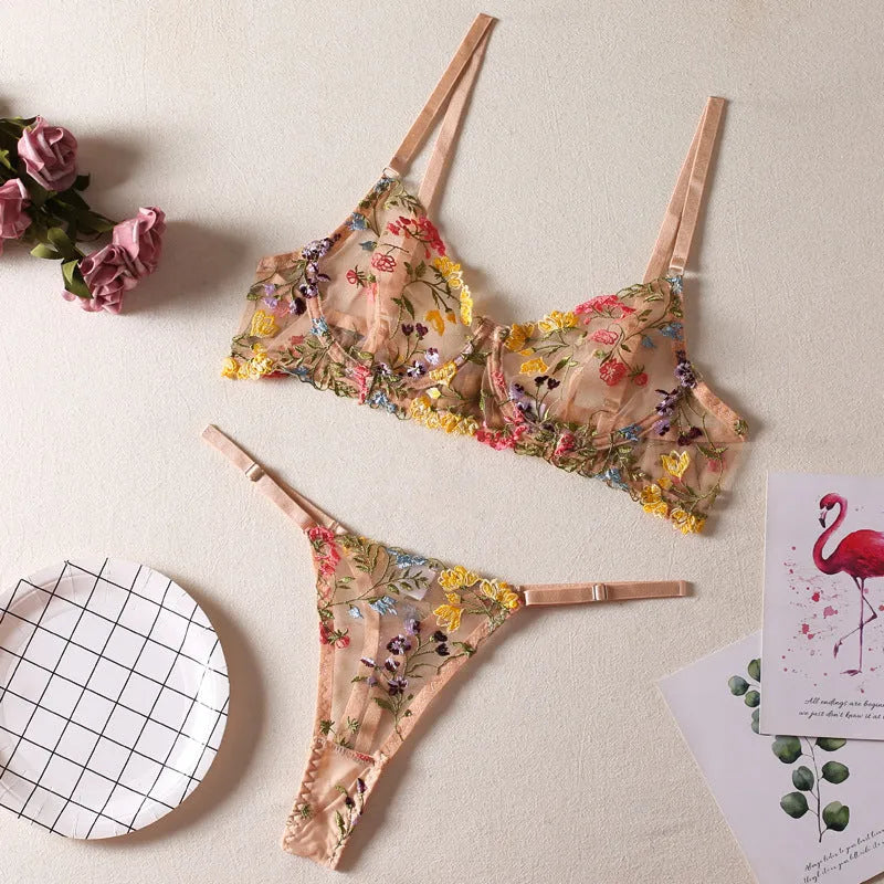 Floral patterned mesh bra with steel ring T-back in various colours on a mannequin.