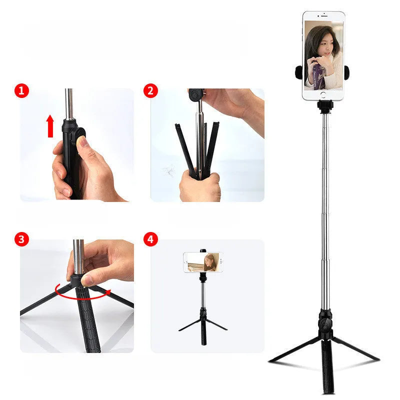 Black Bluetooth selfie tripod with extended stand and 360-degree rotating phone clip attached to an iPhone.