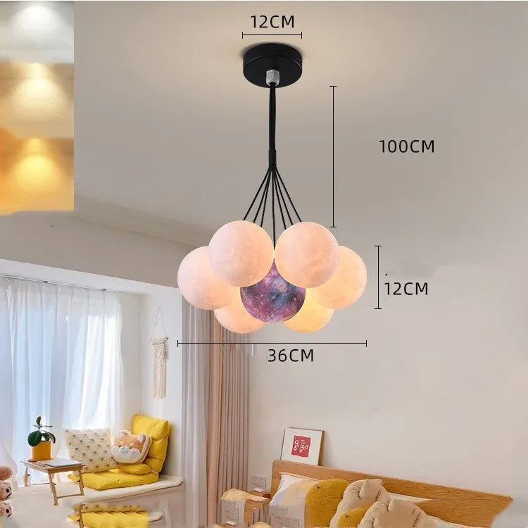 Nordic fish-shaped pendant chandelier with cluster of spherical moon bubble lights in gold or black finish.