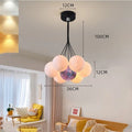Nordic fish-shaped pendant chandelier with cluster of spherical moon bubble lights in gold or black finish.