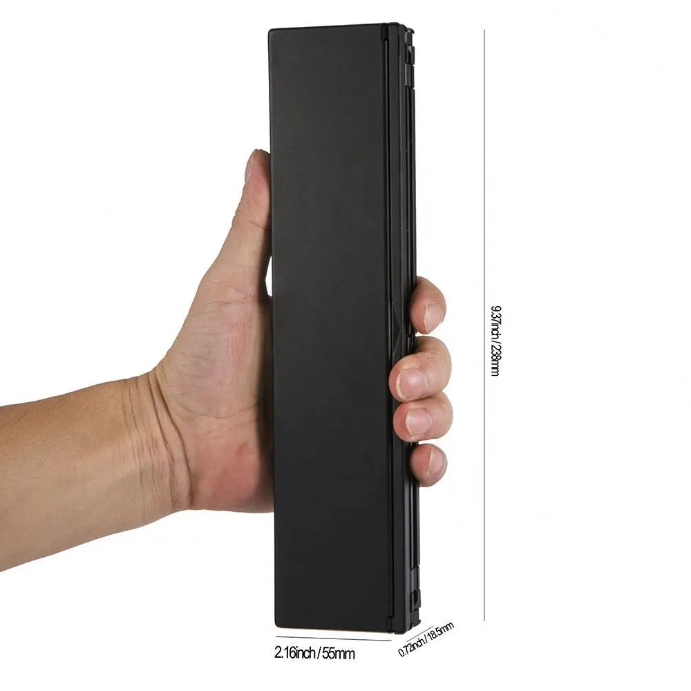 Black foldable Bluetooth keyboard shown alongside tablet demonstrating portable design