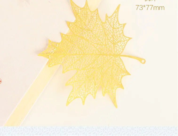 Brass metal bookmark with hollow leaf pattern design and rose gold tassel