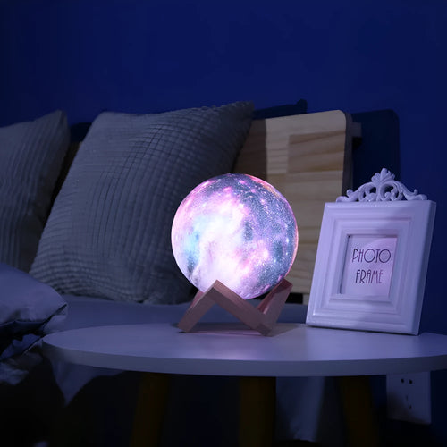 3D-printed spherical lunar night light with remote control on wooden table