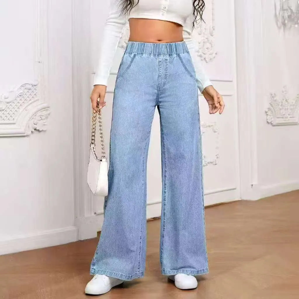 Light blue washed wide-leg denim trousers for plus size figures with mid waist and straight leg silhouette