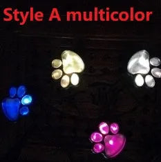 Black bear paw shaped solar garden lights with four paw prints connected to solar panel