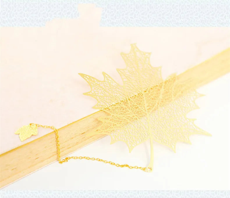 Brass metal bookmark with hollow leaf pattern design and rose gold tassel