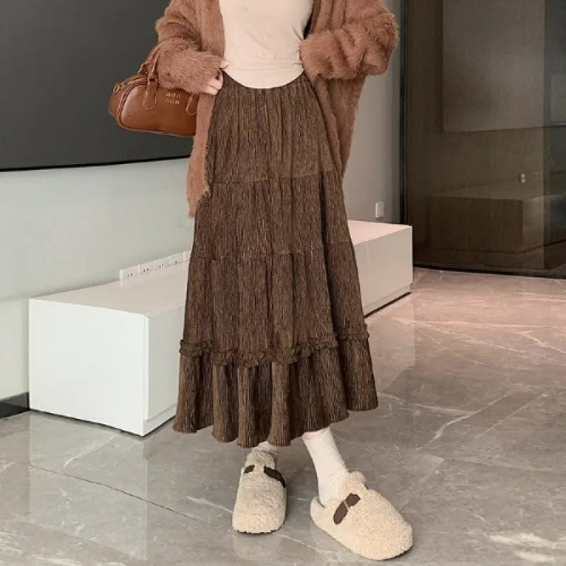 Korean style corduroy A-line midi skirt with an elastic waistband in a solid colour.