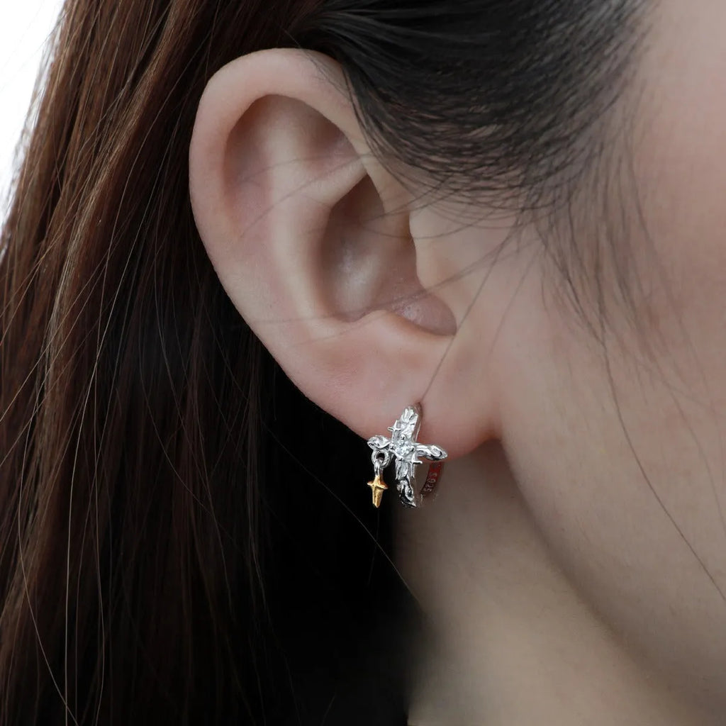 XINGX geometric cross earrings in 925 silver with white gold electroplated finish and circular detail.